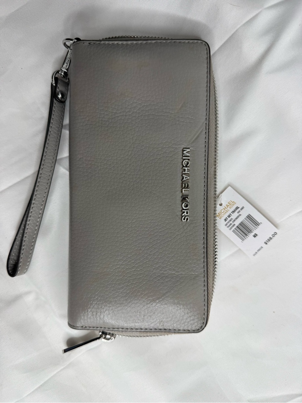 gray leather zip-up clutch wallet with wrist strap from the Michael Kors brand